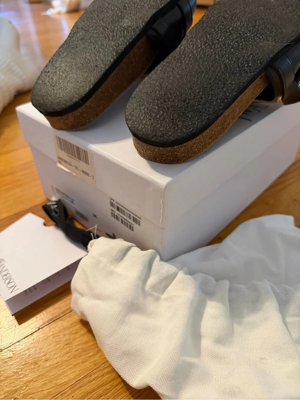 JW Anderson Women’s Black Slide Sandals with Gold Chain Accent